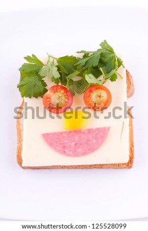 face on bread with cheese,salami,egg,vegetables