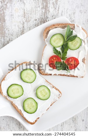 bread with mild cream cheese ,cucumber and tomato