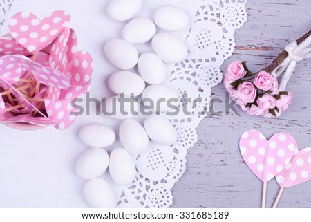 sugar coated almond candy, heart shape papers and flower