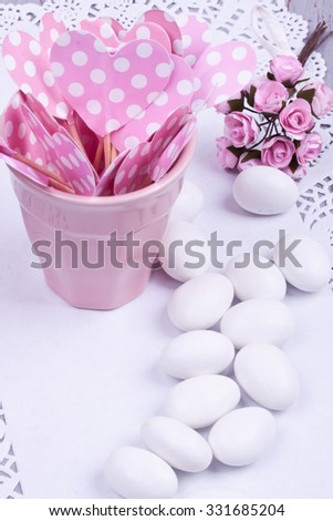 sugar coated almond candy, heart shape papers and flower