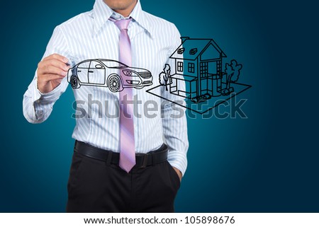 Businessman drawing house and car in a whiteboard.