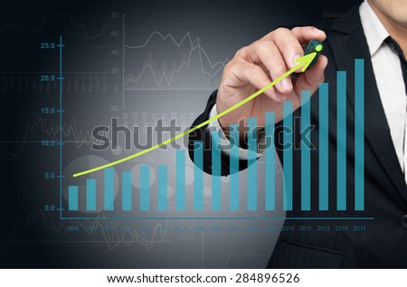 Investor drawing growth chart of profits.