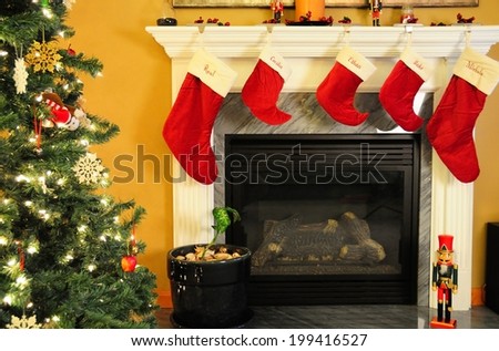 Fireplace, Lit Christmas tree with ornaments, and stockings make for a holiday spirit filled with joy