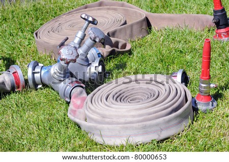 valves and fire hoses in action on grass