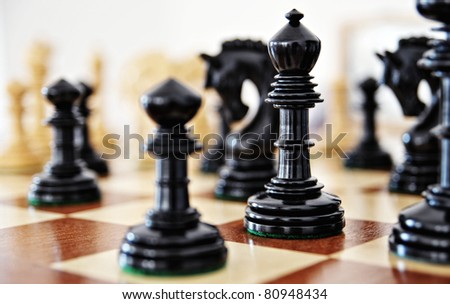 Chess pieces on wood board, black and white