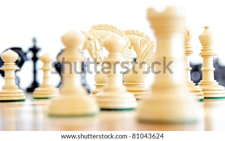 Chess pieces on wood board, black and white