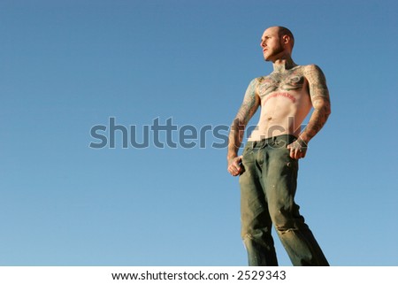 Tattooed man with jeans