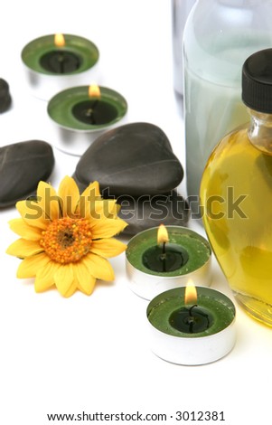 Spa stones, oils and candles isolated on white background