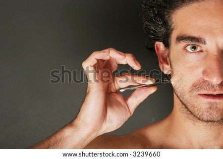 Man pulling his beard with tweezer