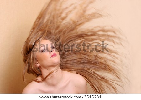 Sexy young woman throwing her hair back