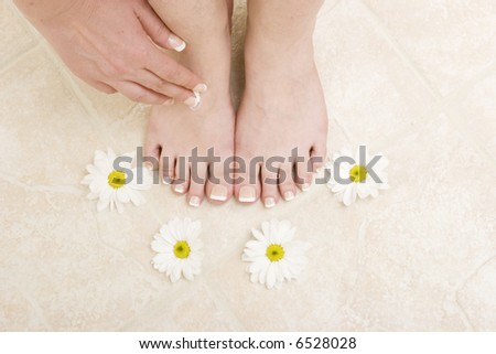 Woman applying cream to her feet