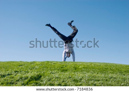 doing summersault on grass