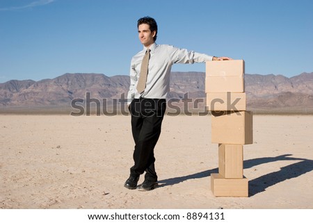 Businessman organizing cardboard shipping boxes