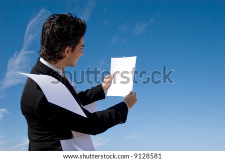 Busy businessman looking over paperwork