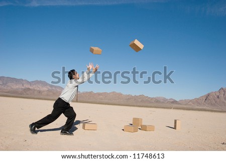 Businessman kicking boxes in the air