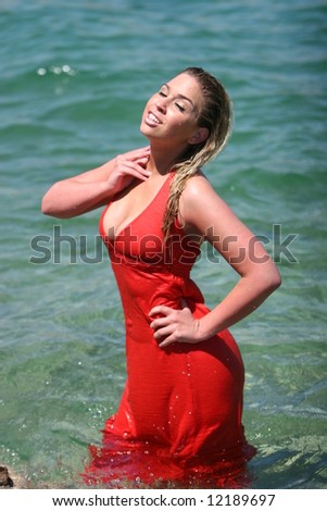 Sexy blonde girl with wet red dress