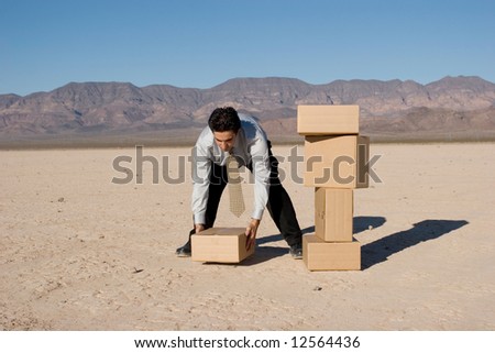 Businessman organizing cardboard shipping boxes