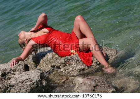 Sexy blonde girl with wet red dress
