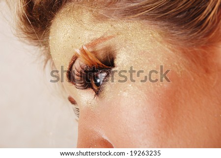 Woman with beautiful gold makeup