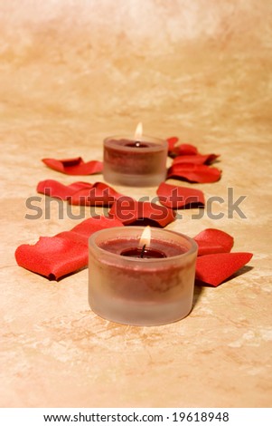 Romantic scented candles and rose petals