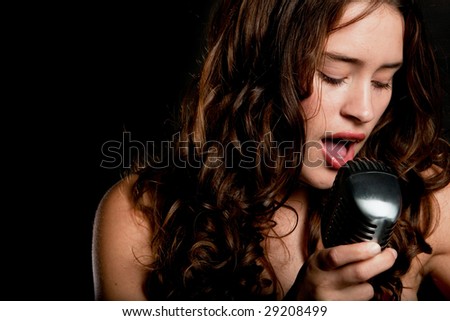 Beautiful singer singing with a retro microphone