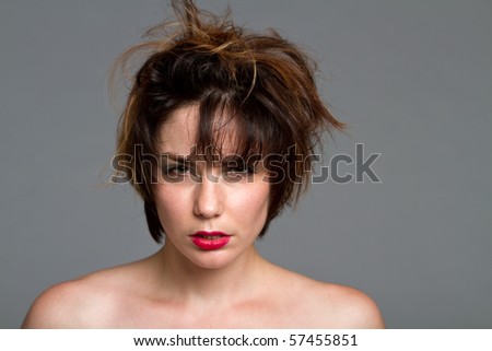 Gorgeous young brunette woman with short messy hair and red lips