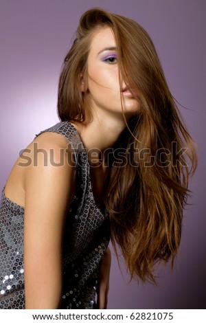 Beautiful young long hair brunette woman with high fashion outfit