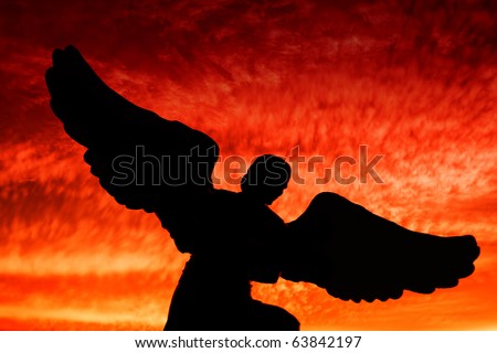 An angel silhouette during dramatic sunset