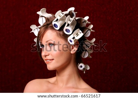 Woman getting her hair curled with hair rollers