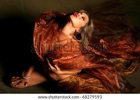 Ethnic woman wrapped in silk material