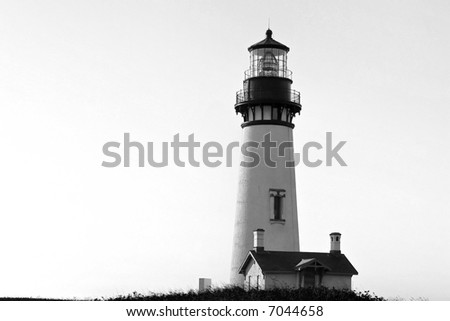 classic black and white image of an old lighthouse in oregon site on top of a cliff