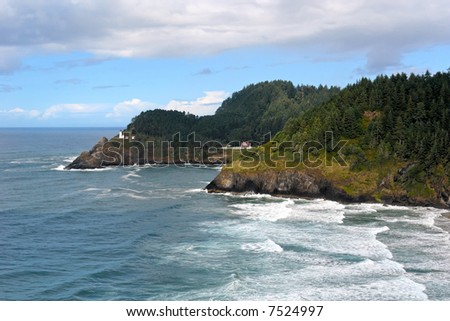 rich beautiful scenic view of the oregon coast with waves crashing and lighthouse off in the distance