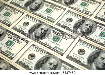 rows of hundred dollar bills laid end to end as a background image