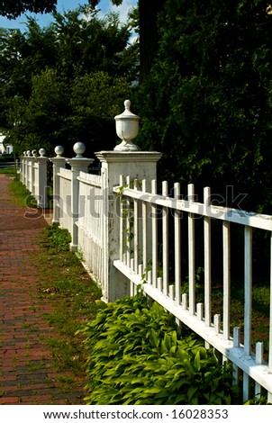 classic new england picket fence stretching off into the distance
