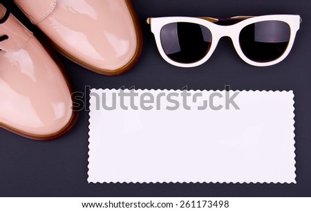 woman\'s set -  shiny beige shoes on low heels, white sunglass. Greating card on dark background