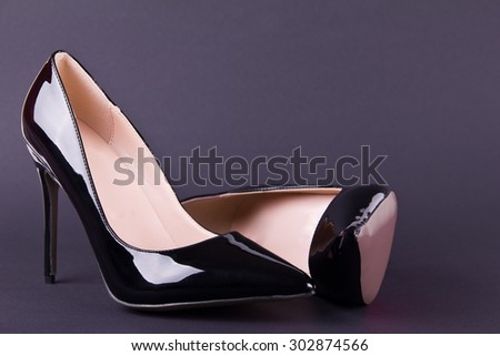 Beautiful classic women shoes on high heels on a black background. Ideal for blogs or magazines.