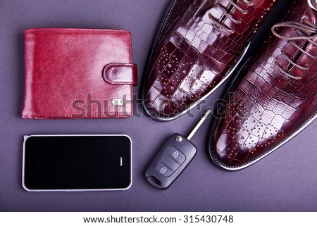 Stylish men\'s shoes, cellphone, car key and wallet on gray background. Crocodile leather.