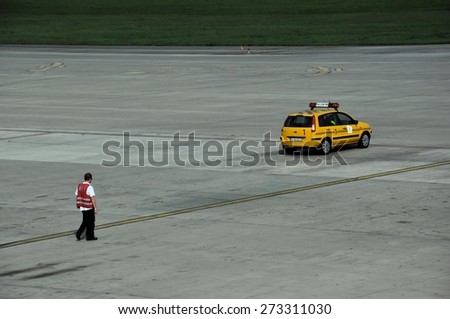KATOWICE, POLAND - SEPTEMBER 3, 2011: An airport services yellow Follow Me car on September 3, 2011 in Katowice Airport, Poland. Follow Me car is indispensable tool for airport marshall.