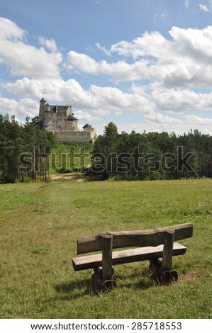 View of Bobolice castle seen from the distance, bench for tourists on the first plan