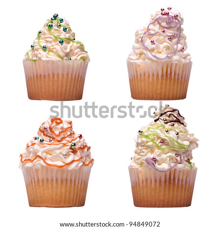 Four cupcakes with whipped cream isolated on white background