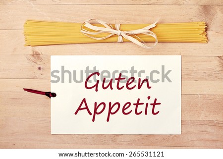 food background - pasta on wood table - german for enjoy your meal