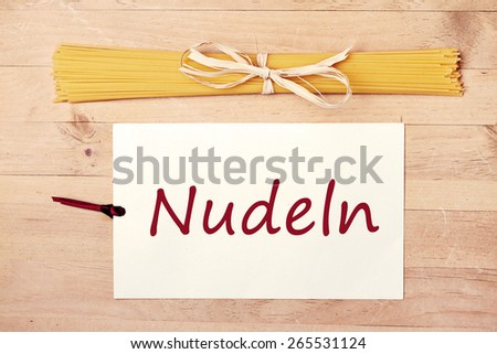 food background - pasta on wood table - german for pasta
