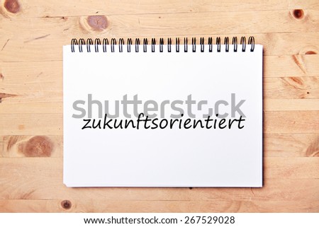 writing pad on wood table  - german for future-oriented
