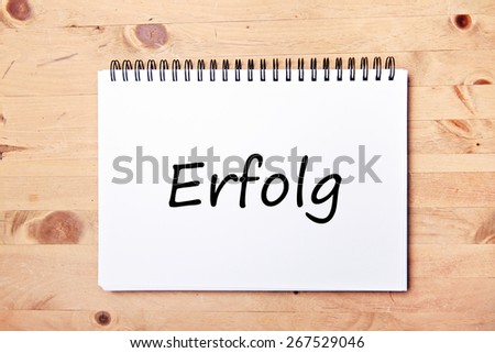 writing pad on wood table  - german for success