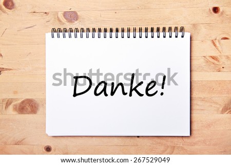 writing pad on wood table  - german for thank you