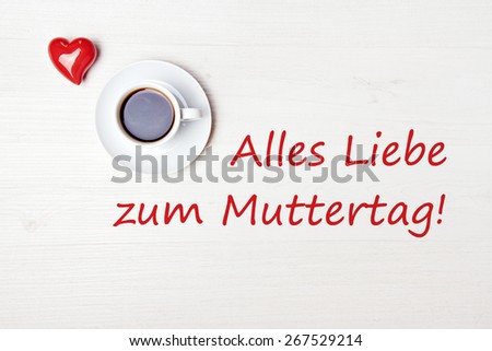 aromatic coffee on wood table with red heart - german for happy mothers day