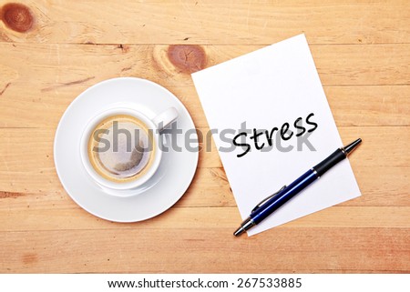 aromatic coffee on wood table with notepad and pen - stress