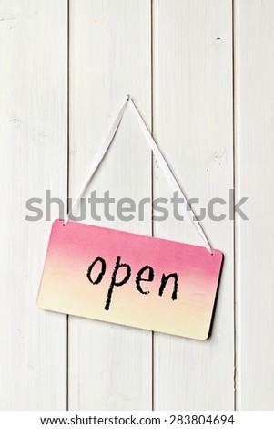 sign on white wood wall - greeting card background open