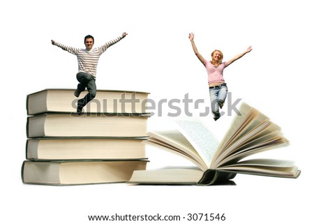 a happy young team - couple is jumping in the air above some books