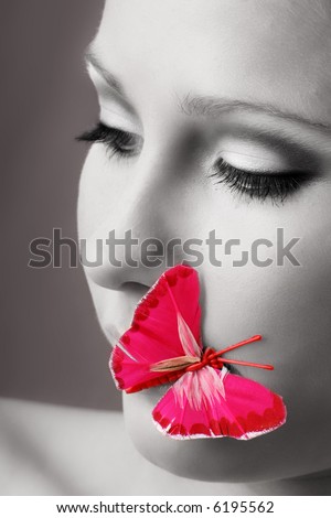 beauty portrait of a beautiful young woman with a butterfly on her face